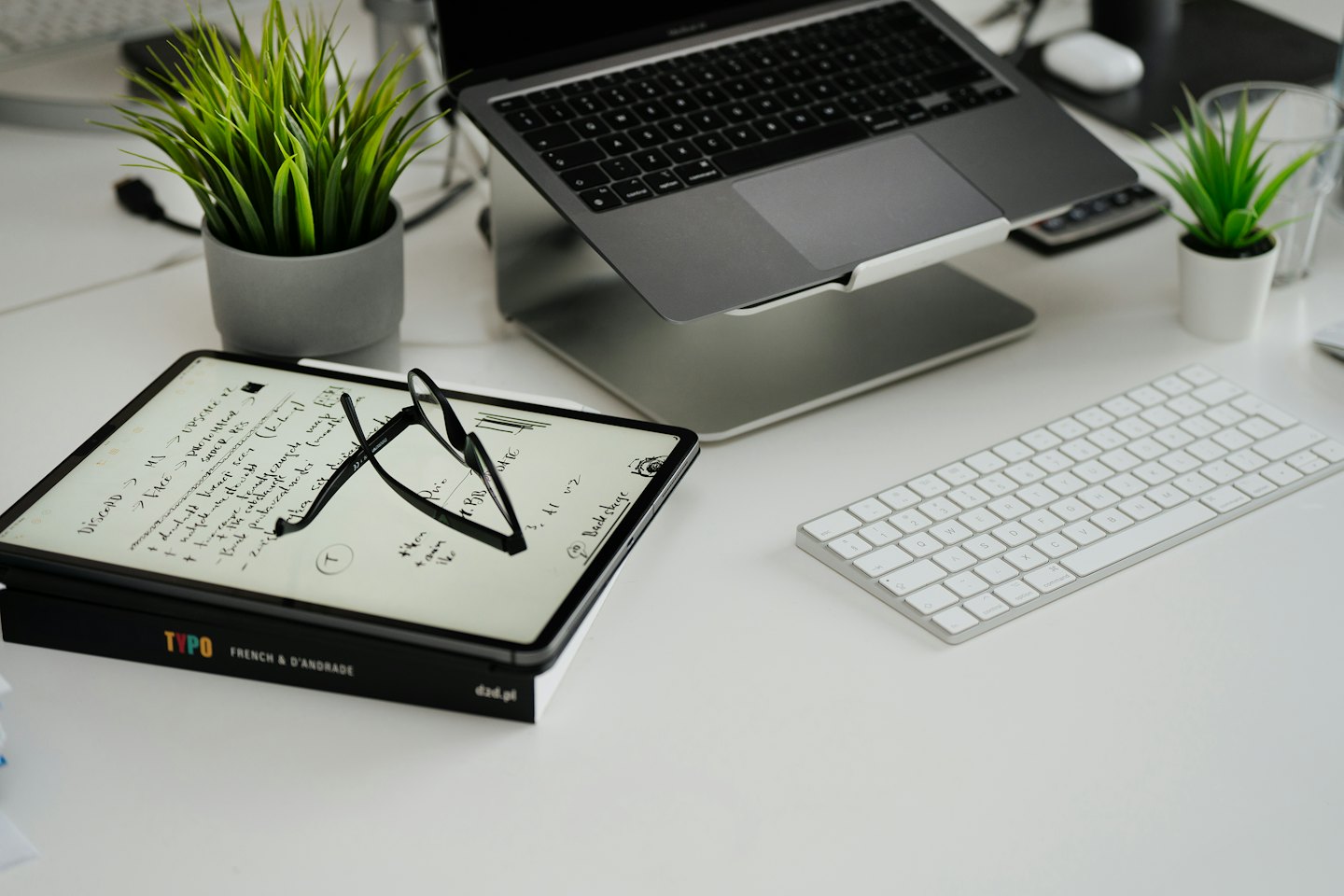 Laptop and tablet on a clean organized modern desk.