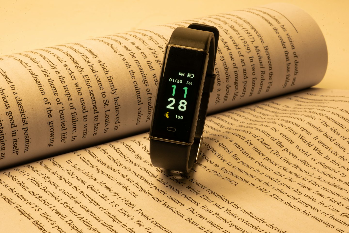 Fitness tracker smartwatch on an open book.